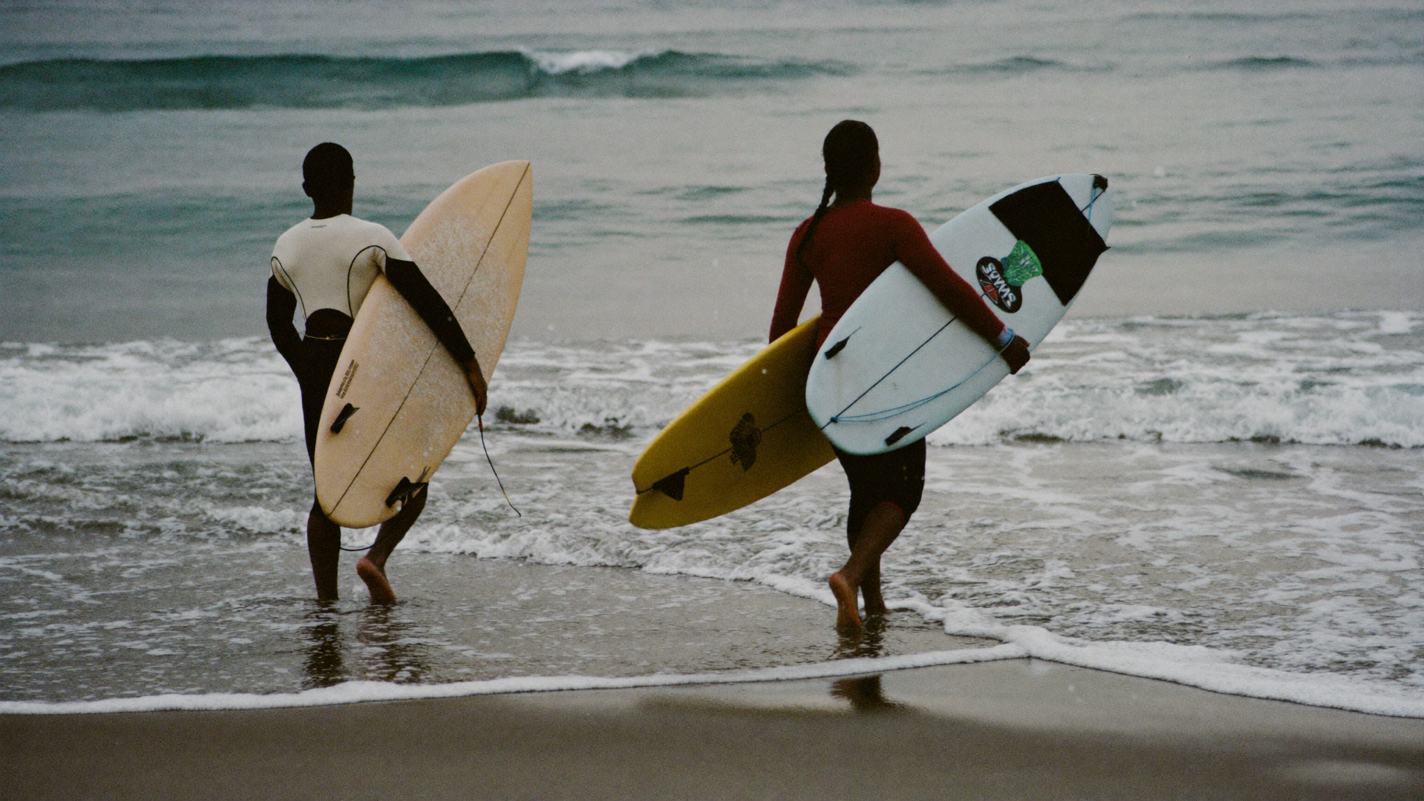 Surfeurs sur une vague à Taghazout au coucher du soleil, Maroc